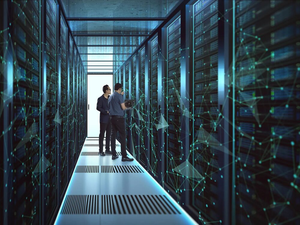 Engineers reviewing servers in a data center aisle